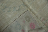 Reverse view of a vintage Oushak showing its hand-knotted construction and secured side cord.