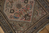 Vintage Hamadan rug corner, intricate Herati mahi-mahi motifs in dusty rose, beige, and blue.