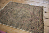 Detailed aged pile of antique Kerman rug, showing foundation and faded red, blue blossoms.