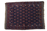 Antique Persian Afshar rug featuring staggered rows of red turtle motifs on a deep navy blue ground.