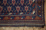 Corner of an antique Afshar showing the intricate kilim end and floral vine main border.
