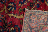 Vintage Lilihan carpet showcasing cherry red floral pile and hand knotted patterned foundation with fringe.
