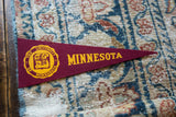 The University of Minnesota's yellow school crest on the vintage maroon felt banner.