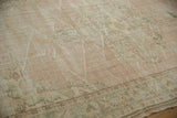 Faded ivory and pale sage abrashes across a vintage distressed Oushak rug pile.