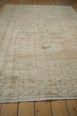 Textured pile of a vintage distressed Oushak carpet, with soft ivory, sage, and rose abrashes.