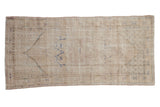Distressed vintage Oushak rug runner with faded cream and blue floral patterns, 2'6