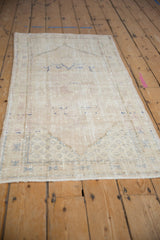 Distressed Oushak rug runner corner, with cream field, blue spandrel, and intact selvage.