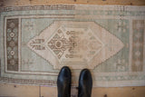 Distressed Oushak rug, hexagonal medallion with Ladik style geometric motifs, ivory and seafoam.