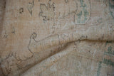 Hand knotted reverse of vintage distressed Oushak rug, revealing foundation with muted tones.