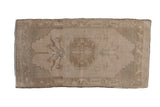 Vintage distressed Oushak mat runner with a roundel medallion in soft beige and ivory, 1'8