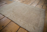 Distressed hand-knotted pile and intact selvage of a vintage Oushak mat.