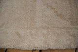 Textured pile of the Vintage distressed Oushak rug showing even wear and abrashed beige tones.