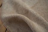 Distressed vintage Oushak rug with soft beige and cream pile texture showing even knot wear.