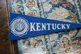 Close-up of circa 1950s blue felt University of Kentucky pennant with white crest.