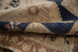 Textured hand-knotted pile of distressed Oushak rug: even wear, navy, ivory, copper tones.