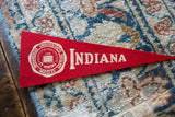 Vintage Indiana University felt pennant tip, with cream 'INDIANA' lettering on bold red.