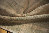 Textural detail of vintage distressed Oushak rug, with worn cream and dusty seafoam pile.