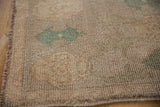 Distressed texture and original side cord selvage of a vintage Oushak rug in ivory and seafoam green.