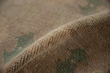 Distressed vintage Oushak rug pile, close-up showing even wear in ivory, seafoam green.