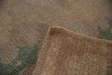 Distressed Oushak rug side cord selvage, showing hand-knotted texture and soft antique tones.