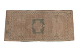 Distressed Oushak hand knotted rug with seafoam green medallion and ivory field.