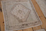 Vintage distressed Oushak rug corner showing geometric border and intact side cord.