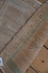 View of the hand-knotted foundation and intact selvage of a vintage Turkish Oushak rug.