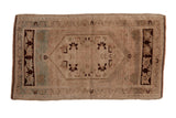 Distressed Oushak rug with an elongated medallion and floral vine border. Beige, chocolate, celadon.