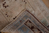 Hand-knotted reverse and distressed beige pile of vintage Oushak rug with celadon border.