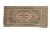Vintage distressed Oushak rug runner with pale green and beige hexagonal floral medallion, 1'9