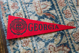 Vintage University of Georgia felt pennant with black school crest and 'GEORGIA' text.