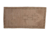 Vintage distressed Oushak mat with a tonal triple medallion design in monochromatic sand and beige.