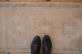 An overhead look at the time-softened texture and even wear of a distressed Oushak rug.