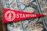 Right side of red felt Stanford pennant featuring cream STANFORD text.