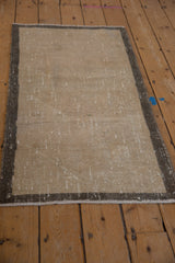 Distressed vintage Turkish Oushak runner, highlighting its beige field and greige border wear.