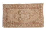 Distressed vintage Oushak rug mat: elongated medallion and scrolling leaves in muted cream and dusty rose.