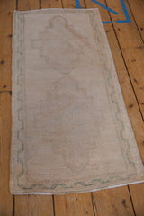 Distressed Oushak rug: cream field with stepped medallion and pale ocean green border.