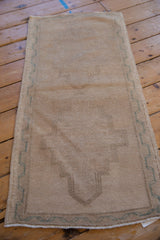 Distressed pile texture, pale ocean green meandering vine border, and selvage.