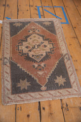 Vintage distressed Oushak rug with dusty copper medallion, charcoal stepped spandrels, and overall wear.