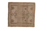 Muted beige distressed Oushak rug mat with an abrashed field and subtle medallion.