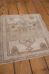 Textured pile of the distressed vintage Oushak rug, showing minor medallion and blossom finials in pale green.