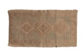 Distressed vintage Oushak rug with triple medallions in muted beige, tan, seafoam green, low pile wear.