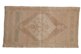 Distressed vintage Oushak rug with a faded diamond medallion and subtle seafoam accents.