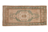 Distressed vintage Oushak rug runner, faded emerald green medallion with floral motifs.