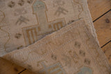 Distressed Oushak rug detail with worn pile revealing foundation and woven reverse.