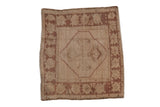 Distressed vintage Oushak rug, soft ivory field, central quatrefoil, worn copper palmette border, 1'10