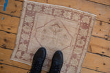 Distressed Oushak rug corner with palmette border and original side selvage.