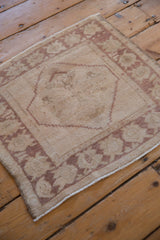 Even wear across knot heads and time-softened colors of this vintage Oushak rug.