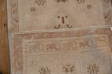 Hand-knotted beige and sand foundation of a vintage Oushak rug, showing intact side selvage.