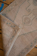 Distressed vintage Oushak rug showing even pile wear, intact selvage, and woven foundation.